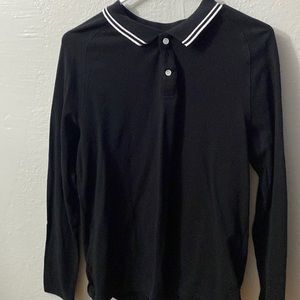 Not sure what to call it but it’s a black shirt with a white striped collar